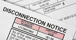 A utility disconnection notice showing account number and overdue amount due for payment.