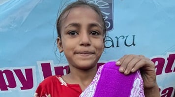 Girl holding up a Hanaru reusable sanitary napkin