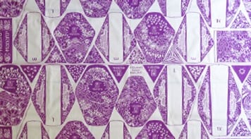 Length of fabric showing grid for printing reusable sanitary napkins