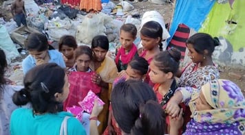 Ambassador Pooja G with a group of ten girls.
