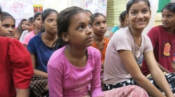 A group of girls listening to a talk on menstrual education