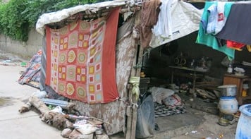 Slum dwelling on roadside.