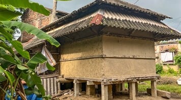 Traditional wooden and mud home with no windows.