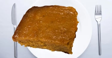 crustless sweetpotato pie hovering over white plate and fork and dinner knife