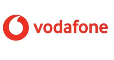 a woman in a red dress and a white shirt with the words vodafo