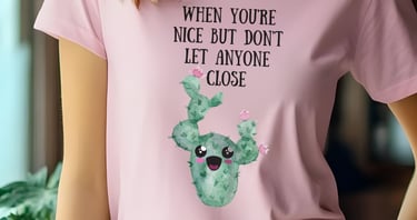 Woman wearing a pink graphic plant t-shirt with a cute smiling cactus design from Miss Chatty Plants.