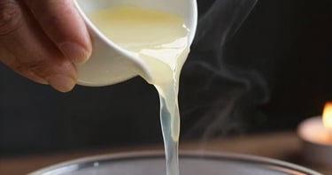 Extreme close-up of aged hands pouring molten wax from a ladle into a bowl of cold water, candlelight from below catching the wax stream mid-pour, dark background, smoke curling at the edge, no faces visible