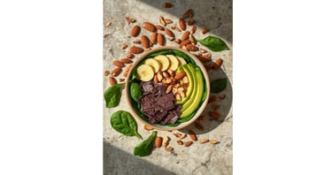 Healthy smoothie bowl with dark chocolate, avocado, banana, and almonds on a bed of spinach.