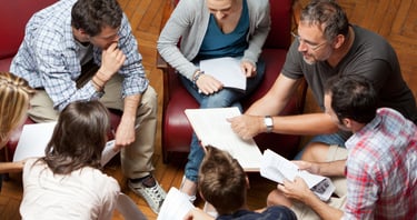 a group of people sitting around a table