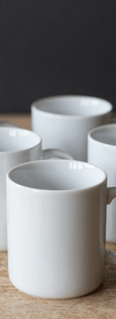 A colorful display of custom printed mugs arranged neatly on shelves.