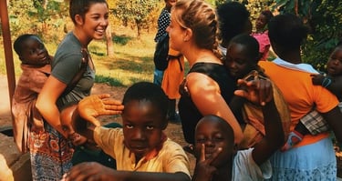 Village children playing and interacting with tourists during a lively Zanzibar village tour