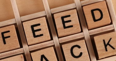 a wooden block with the words feedback on it