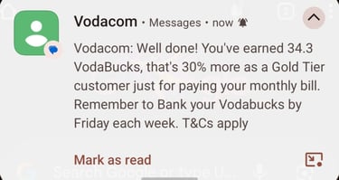 A mobile phone notification from Vodacom detailing VodaBucks rewards earned for paying a monthly bill.