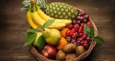 Healthy fruits in bowls with a nutrition booklet: fresh apples, blueberries, strawberries,