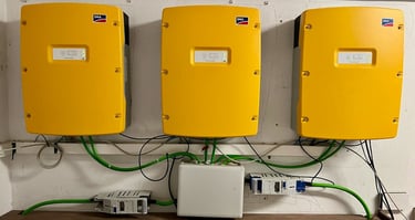 three yellow SMA sunny island on a wall in a garage