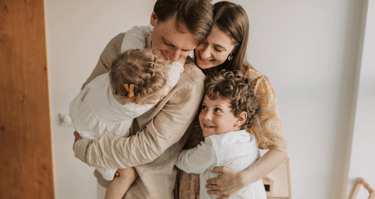 a man and two children are holding their hands while they are holding a baby