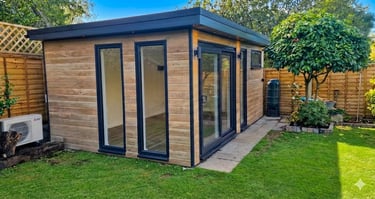 Modern cedar effect garden room with black trim and sliding glass doors