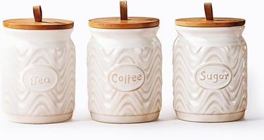 three jars with wooden lids and a wooden lid