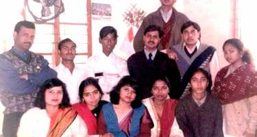 a group of people standing around a man in a suit and tie