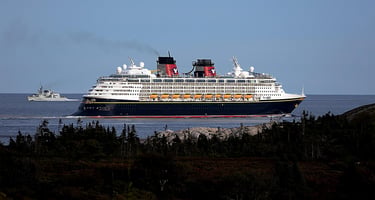 Disney Magic ocean cruise ship underway—Disney Cruise Line family cruises, coastal scenery