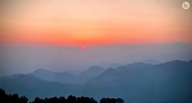 Sunset view from Naddi View Point, McLeod Ganj with clouds and Dhauladhar mountains.