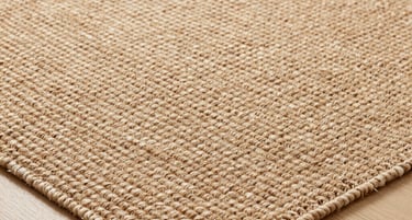 A moody walnut-toned living room bathed in warm amber light, showcasing a serene and inviting atmosphere.