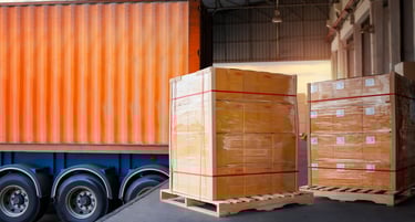Cargo pallets on warehouse dock, semi truck with shipping container, Specialty Logistics, Louisville