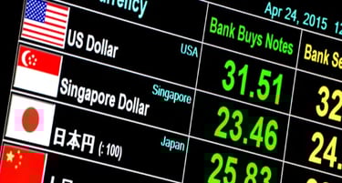 Digital foreign exchange rate board displaying US Dollar and Singapore Dollar bank buy prices.