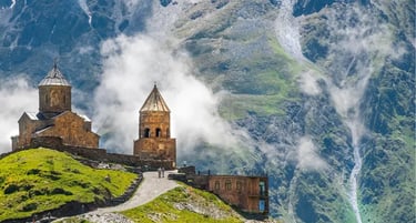 Gergeti Trinity Church in Kazbegi, Georgia, nestled against the misty Caucasus Mountains.
