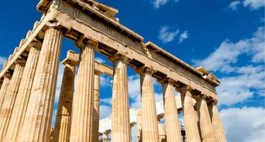 The ancient Parthenon temple on the Athenian Acropolis in Greece under a bright blue sky.