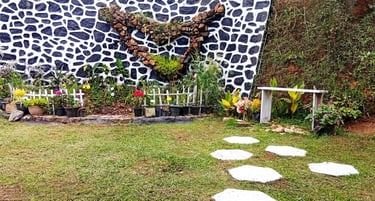 Pond and flower garden with bench at Nobel Bungalow Nuwara Eliya – peaceful outdoor space