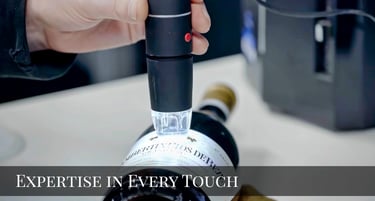 Professional warehouse specialist carefully handling premium whisky bottles with white gloves