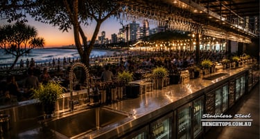 Commercial under-bench fridge line and durable stainless steel bench Coolangatta at dusk.