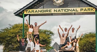 Group photo of tourists at the main entrance of Tarangire National Park in Tanzania before starting a safari adventure