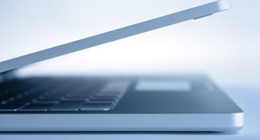 a laptop computer sitting on a table with a laptop