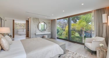 Contemporary designer suite at Villa Serenity, offering serene views of the lush gardens