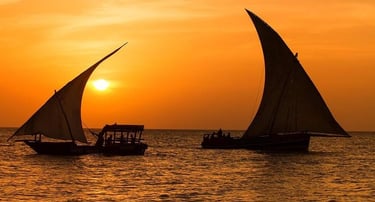 Romantic sunset views aboard a classic Zanzibar dhow cruise, with golden skies and calm waters.