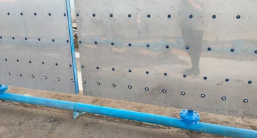 Engineering vehicle washing machine spray piping installation along washing channel wall