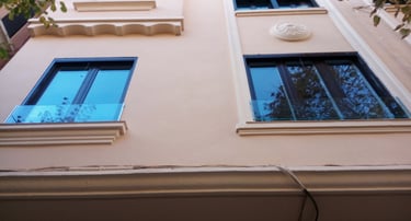 Ventanas y quita-miedos de vidrio en fachada edificio.
