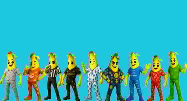 a group of five bananas and a man in a costume