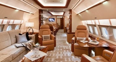 Luxury private jet interior featuring spacious seating, refined wood finishes, and VIP amenities. Designed for executive trav