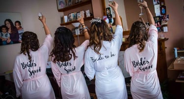 bride and bridemaid raising a glass of champagne