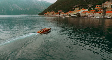 Couple walking along Perast waterfront, romantic Montenegro wedding photography