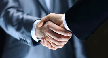 a man in a suit and tie is shaking hands