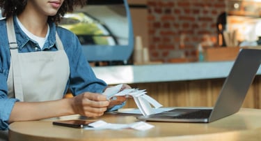 a woman in aprons and aprons is holding a credit card. accounting. taxes.