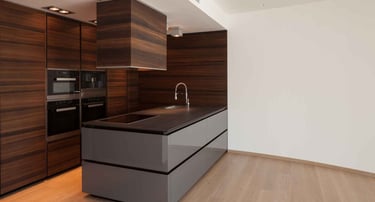 Kitchen with a brown quartz countertop, featuring a cooktop and a sink.