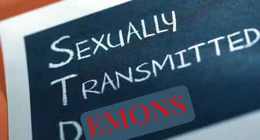 Close-up of text reading Sexually Transmitted Demons written in chalk on a blackboard.