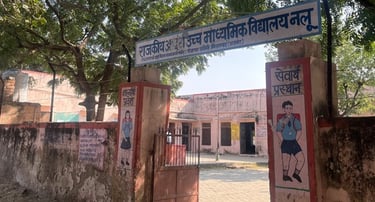 Looking through school gate at school Pink paint pealing off walls.