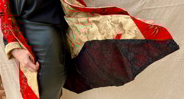 Inside of red cotton, black lace, and gold butterfly coat