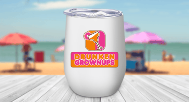 Wine tumbler at a beach scene with a colorful margarita glass logo that features a donut, not a lime & says drunken grownups.